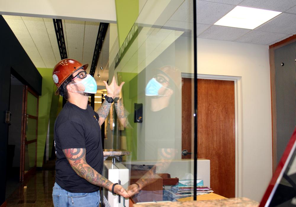 Man installing glass partition